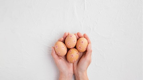 Top view hands holding decorated easter eggs