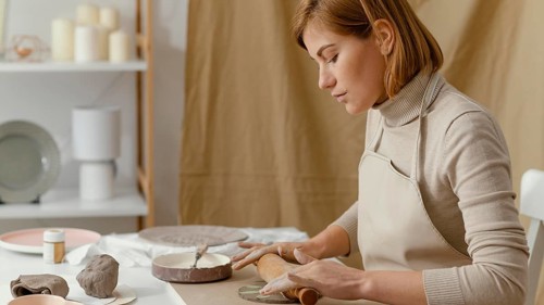Close up woman working with rolling pin