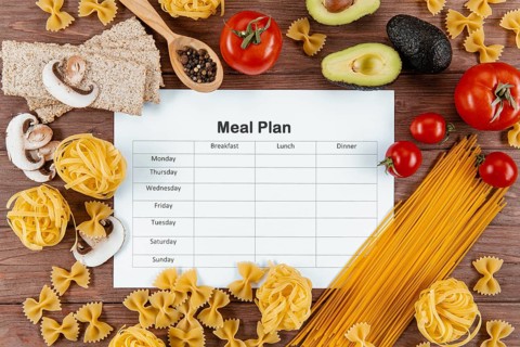 Top view meal plan with pasta avocado