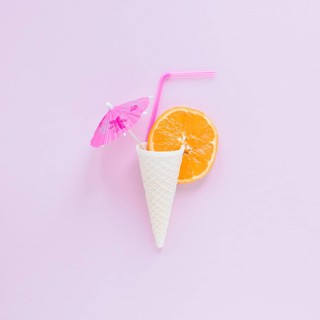 Waffle cone with orange straw umbrella table