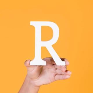 Deaf woman s hand holding r alphabet