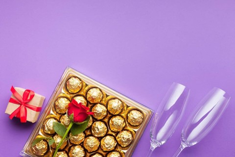 Flat lay frame with chocolate box gift