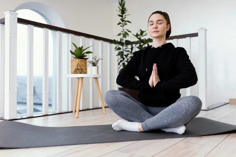 Female meditating indoor