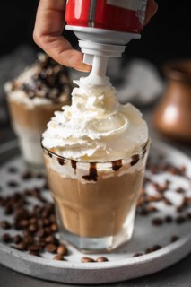 Close up glass coffee with cream