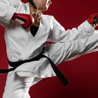 Woman jumping with box gloves red background