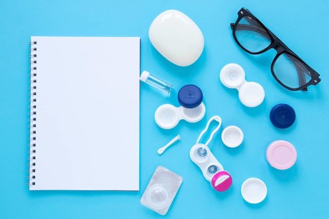 Eye care products blue background with notebook mock up