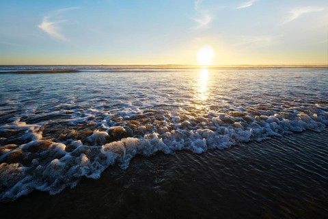 Atlantic ocean sunset with surging waves at Fonte da Telha beach