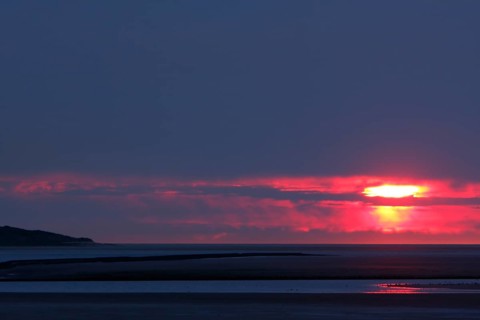 View from the island of Minsener Oog to Wangerooge at sunset