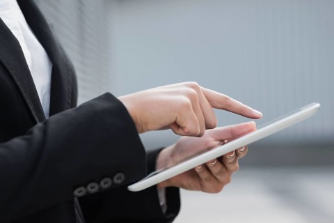 Close up hand pointing ipad