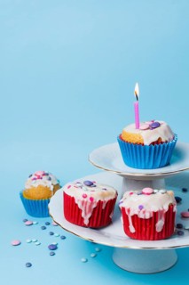 Birthday cupcakes arrangement blue background