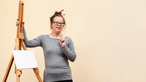 Front view girl down syndrome posing easel