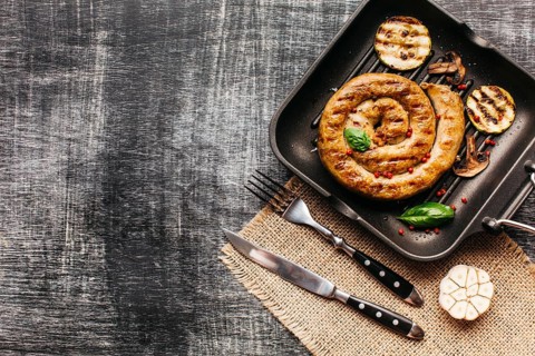 Tasty snail sausage garnish with red peppercorn basil