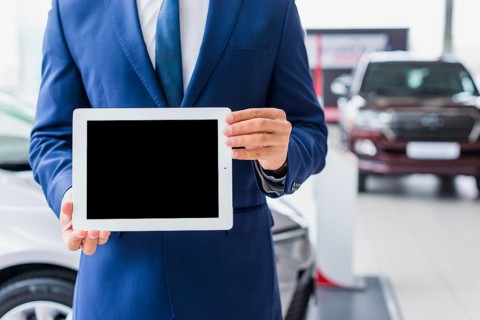 Car salesman with tablet