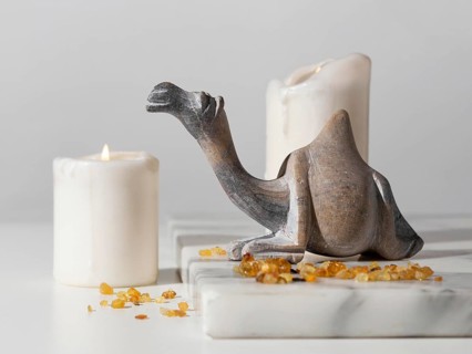Epiphany day camel figurine with raisins candles