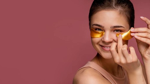 Beautiful woman using eye patch masks