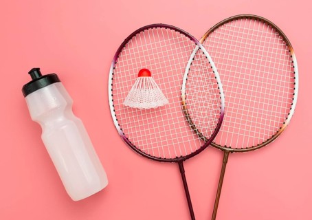 Flat lay badminton set with water bottle