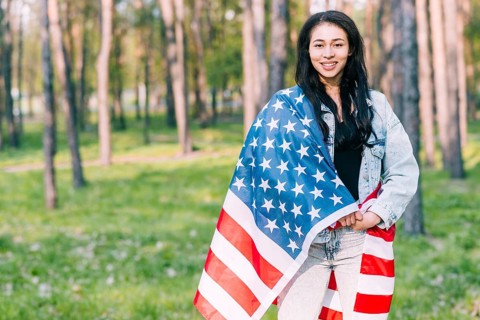 Young female covered with flag usa