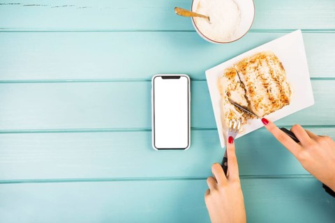 Elevated view woman s hand cutting lasagne