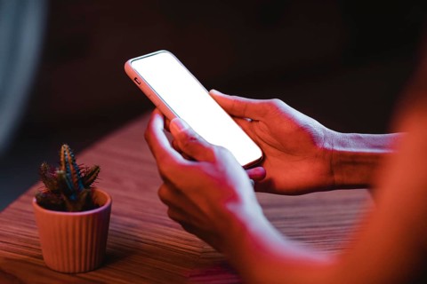 Side view man holding smartphone