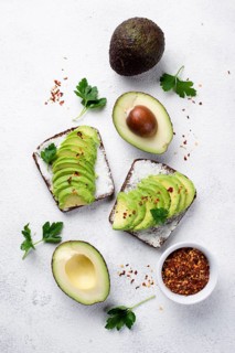 Flat lay avocado toast breakfast with herbs spices