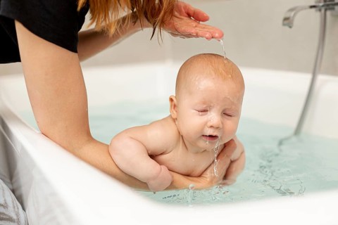 Close up mother washing her baby