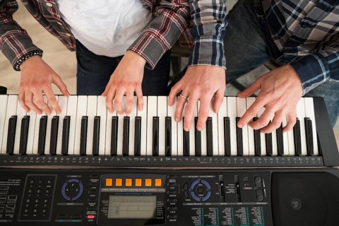Father daughter playing piano
