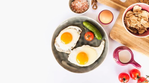 Fried omelette with tomato cucumber plate white background
