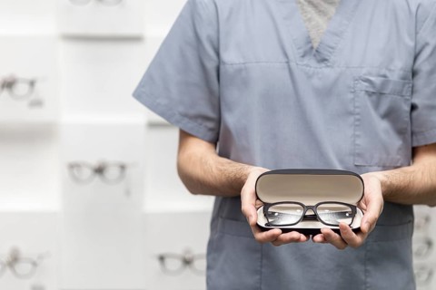 Front view man holding pair glasses case