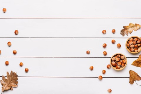 Hazelnuts leaves white table