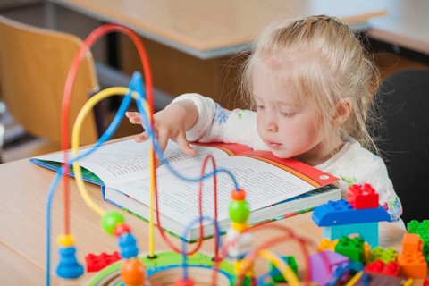 Cute toddler reading book