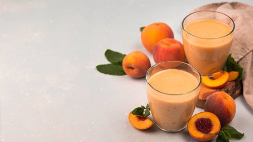 High angle milkshake glasses with peaches copy space