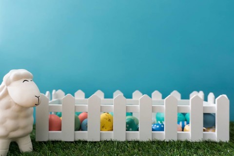 Easter background with sheep wooden fence