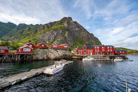 Traditional red rorbuer wooden cabins with stockfish museum