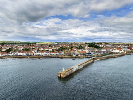 Aerial view of the fishing village of Pittenweem on the Firth of Forth with quay wall and lighthouse