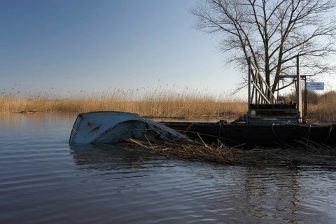 Capsized boat at the jetty of the Lower Weser island Strohauser Plate after a storm surge