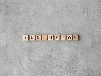Inclusion word written scrabble letters marble background