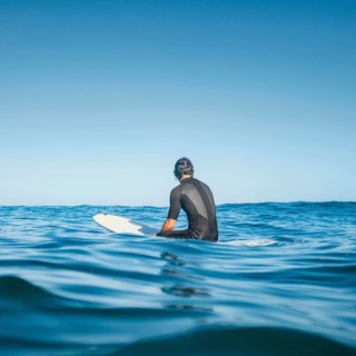 Man sitting water from