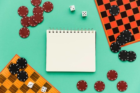 Top view society games with mock up notepad