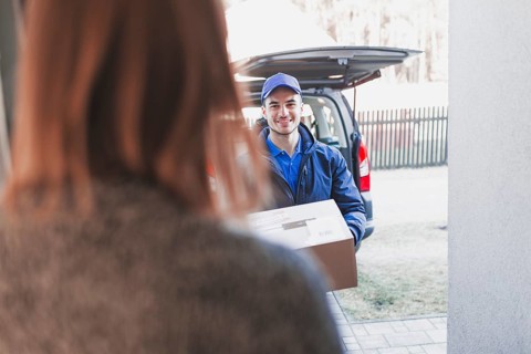 Woman greeting deliveryman porch