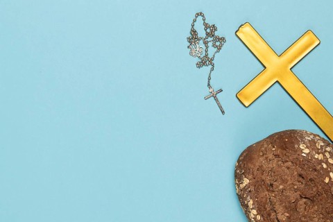 Copy space holy cross necklace with bread