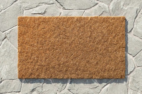 Overhead of blank doormat on the rock tile porch