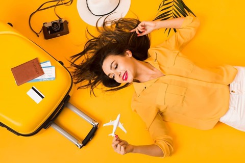 Flat lay woman posing travel essentials