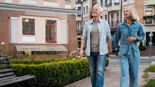 Front view if older couple holding hands city