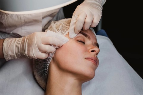 Young woman getting beauty procedure wellness center