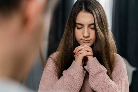 People praying home before dinner