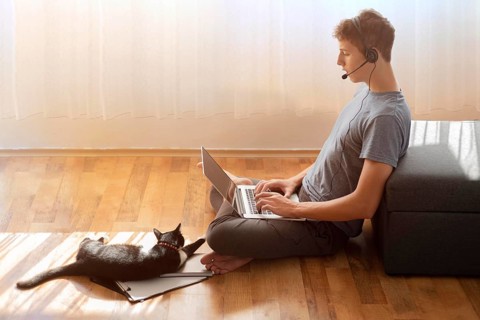Side view man using laptop home quarantine work