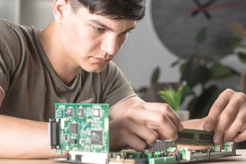 It technician students inserting ram computer motherboard