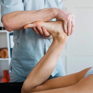 Male physiotherapist female patient during massage session