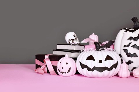 Pink and white Halloween decor with black and white pumpkins