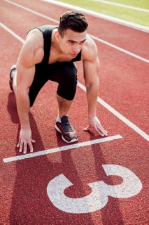 Muscular male young runner start line